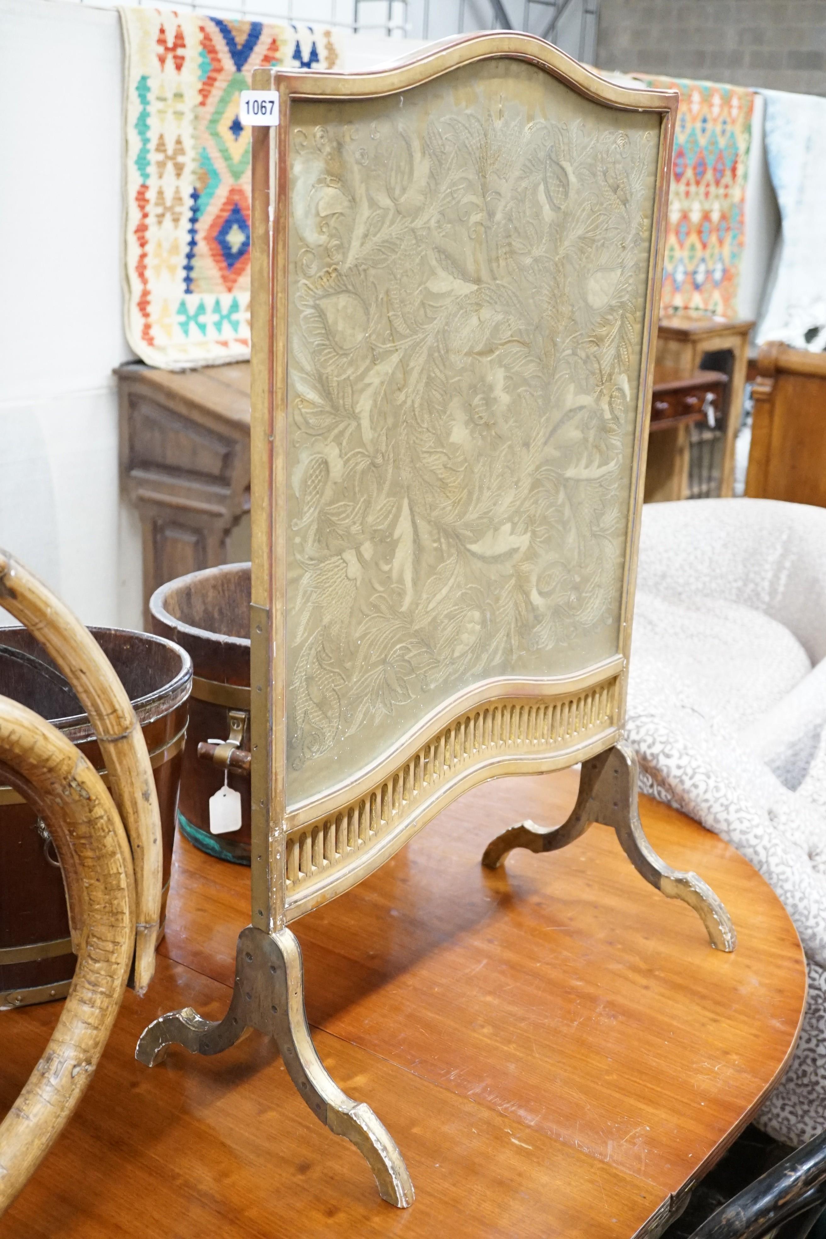 A carved gilt wood fire screen with internal needlework panel, width 56cm, height 92cm
